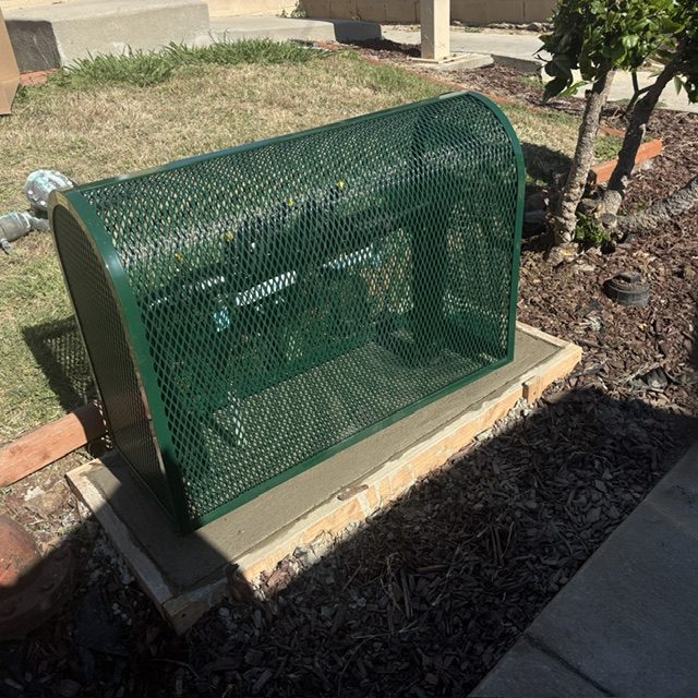 Steel mesh security enclosure protecting a backflow prevention assembly