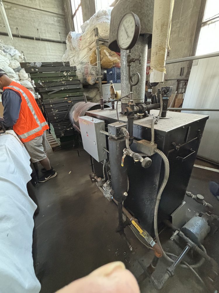 Inspector surveying process equipment and gauges inside an industrial facility